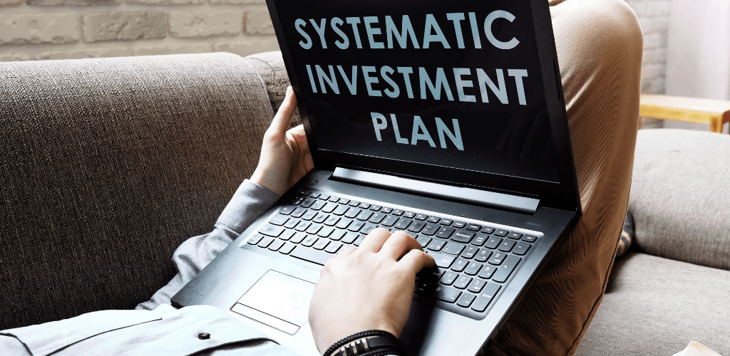Person viewing 'Systematic Investment Plan' text on the laptop screen